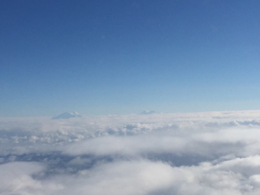 Denali and Mt Foraker peeking above the clouds at us, flying at 8,000 feet.