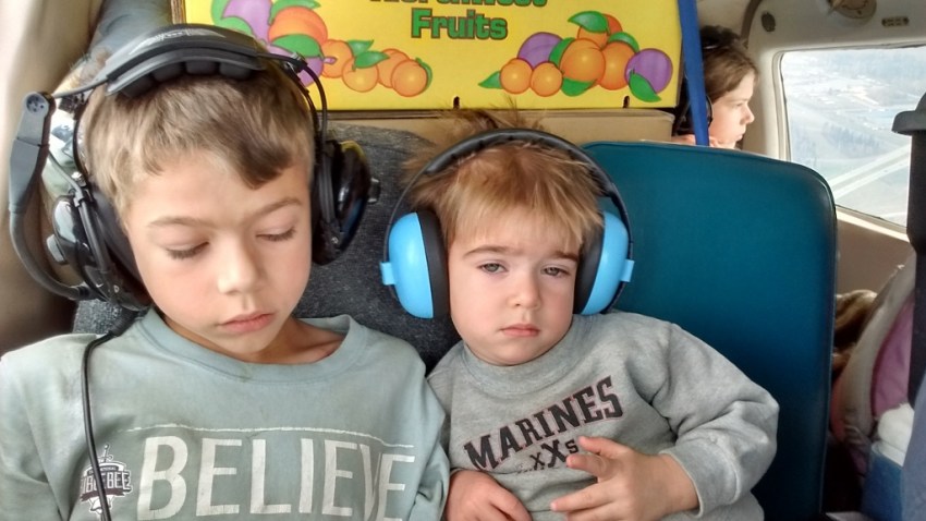 Timothy's first flight in his own seat. (He wasn't unhappy as appears; picture was just snapped at a less than optimal moment.)