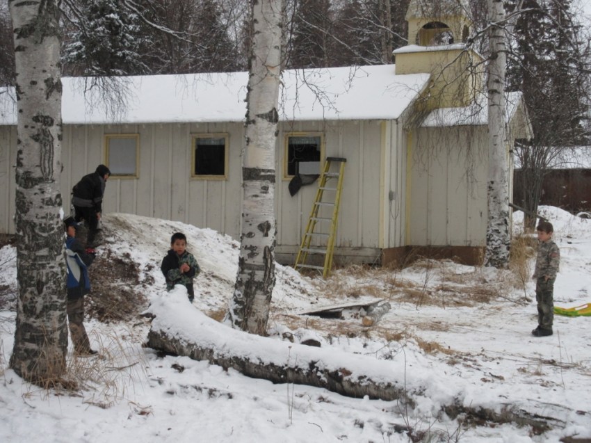 Taken from the house's front porch, viewing left: "the boys" use the small hill for a little sledding on the fresh snowfall.