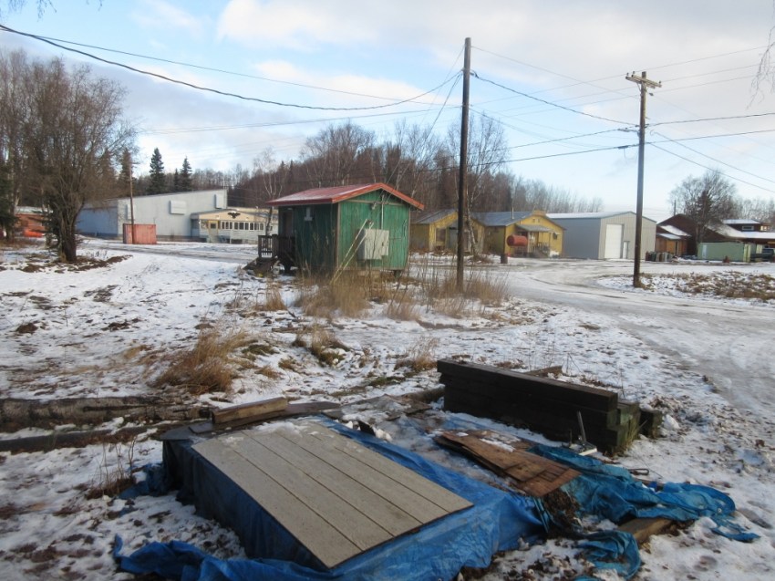 Taken from the house's front porch. From the left: blue building in background is the school, green building services the sewer, brown building is the Native Store, gray warehouse, Tribal Hall